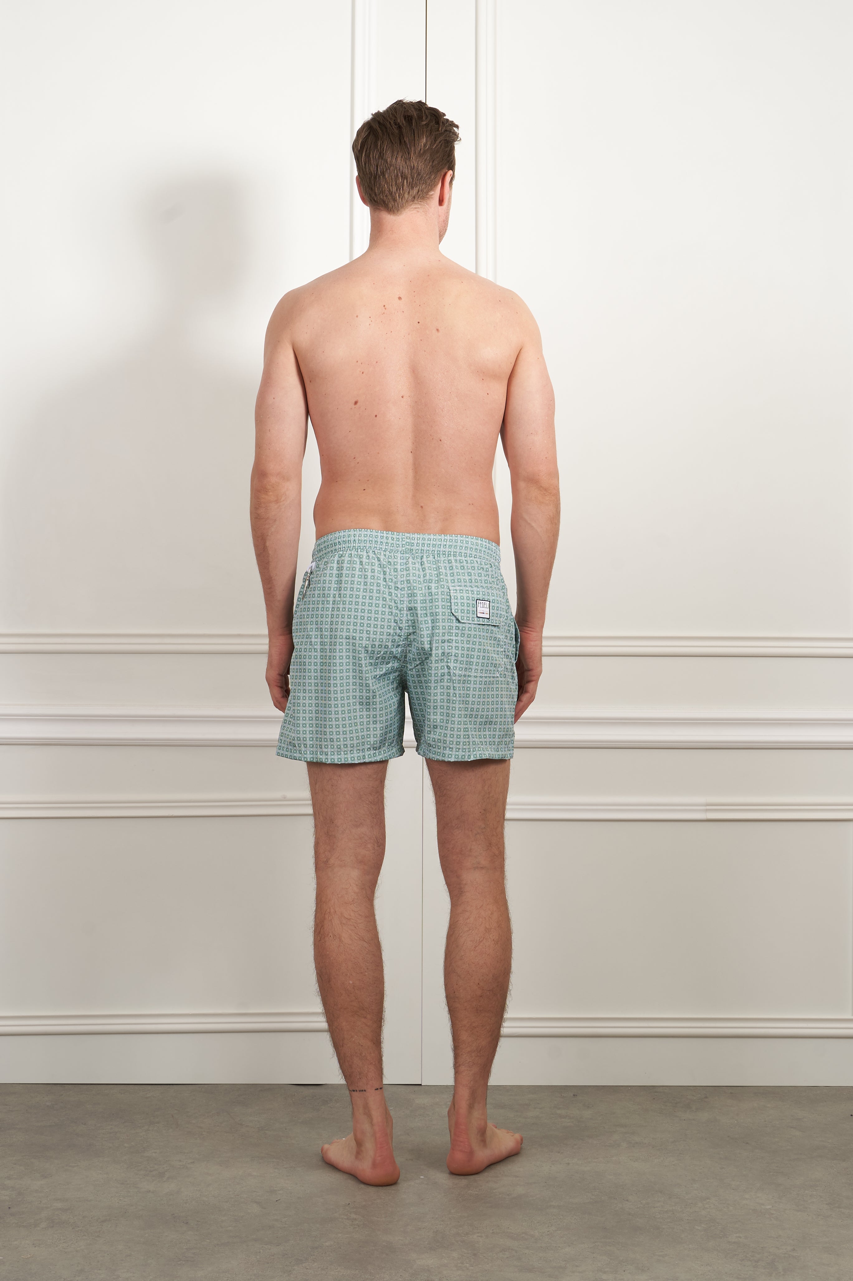 Swimming trunks in green and white